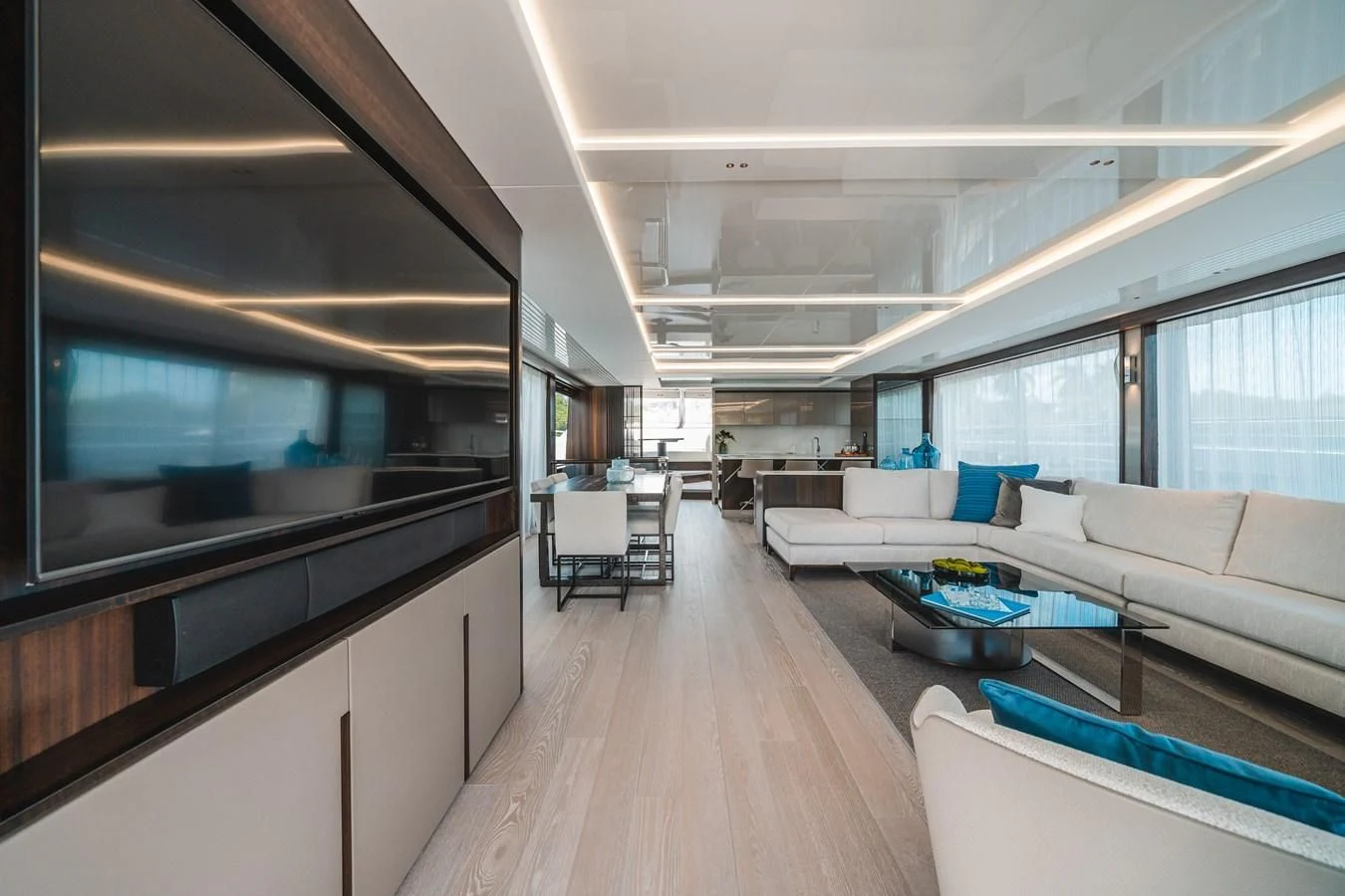 a room with a wood floor and white couches aboard 90 OCEAN Yacht for Sale