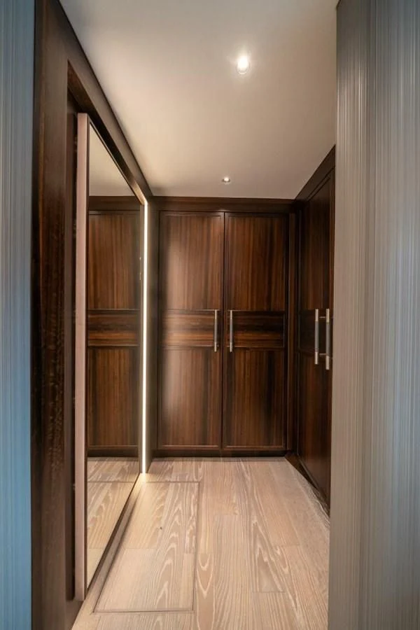 a room with wooden cabinets aboard 90 OCEAN Yacht for Sale