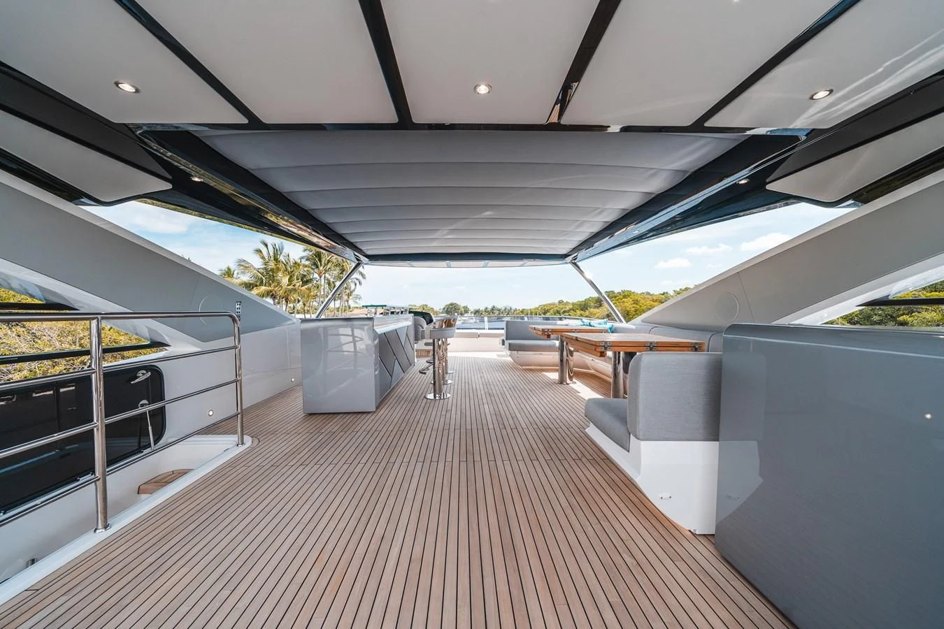 a covered area with a bench and a table aboard 90 OCEAN Yacht for Sale