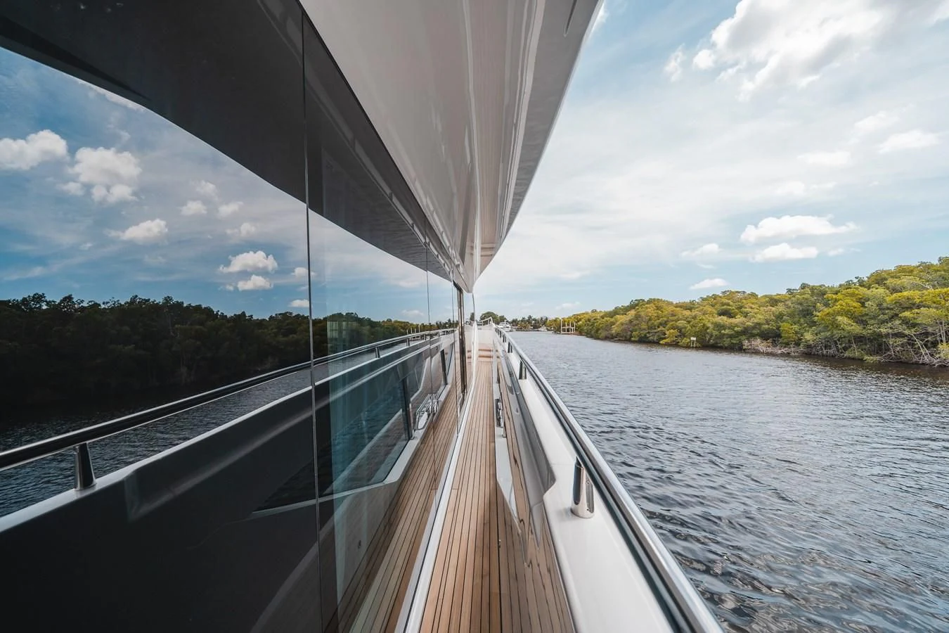 a boat on the water with Sundial Bridge at Turtle Bay in the background aboard 90 OCEAN Yacht for Sale