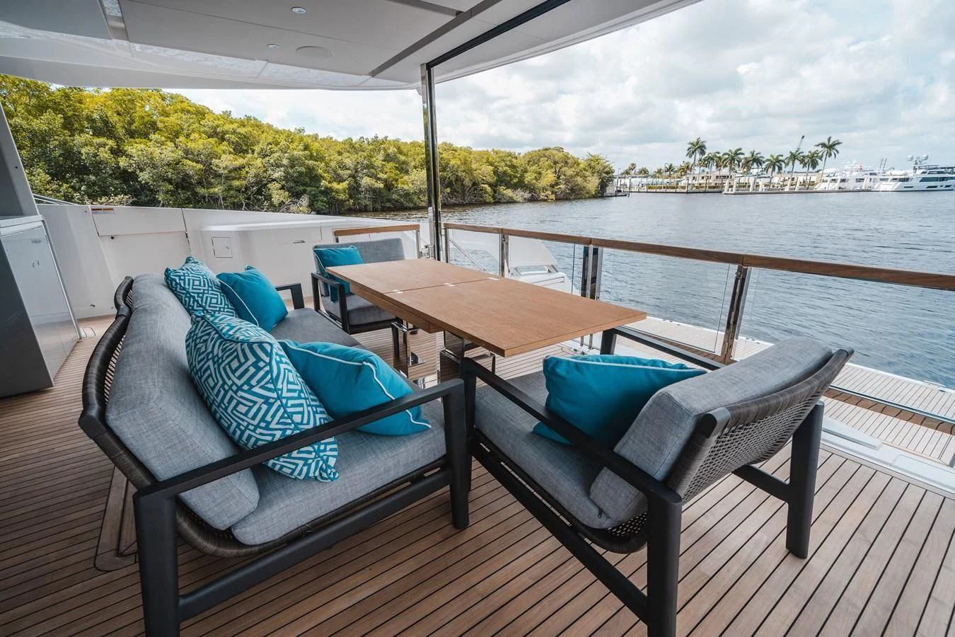 a table and chairs on a deck aboard 90 OCEAN Yacht for Sale
