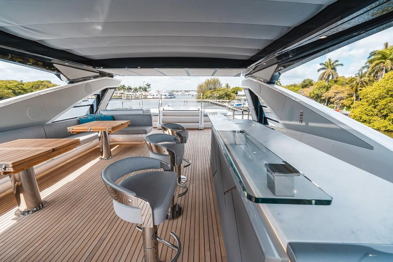 a deck with a table and chairs aboard 90 OCEAN Yacht for Sale