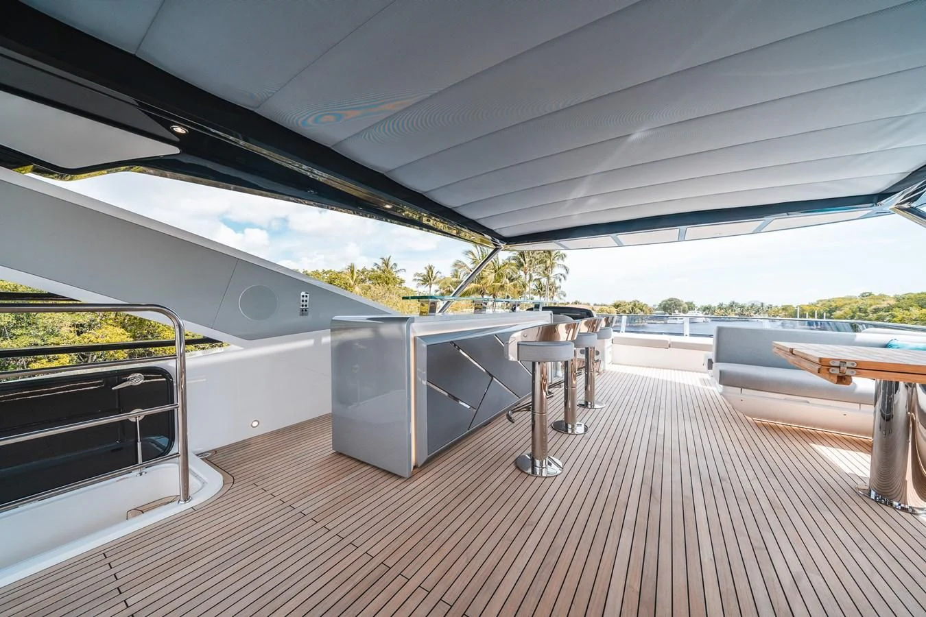 a covered patio with a table and chairs aboard 90 OCEAN Yacht for Sale