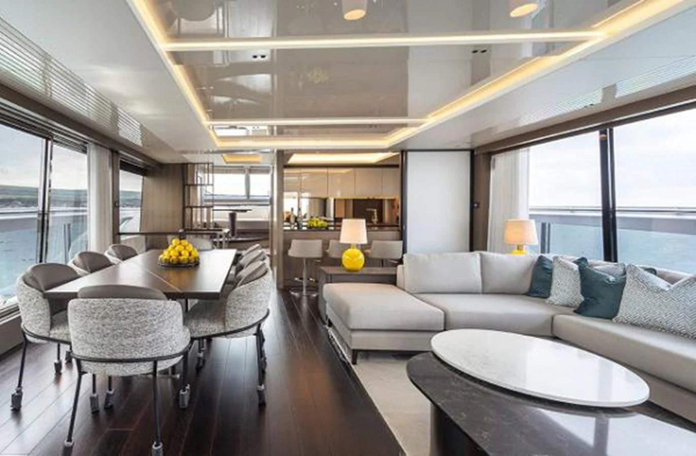 a living room with a large table and couches aboard 90 OCEAN Yacht for Sale