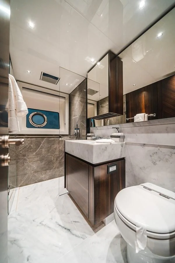a bathroom with a toilet and sink aboard 90 OCEAN Yacht for Sale