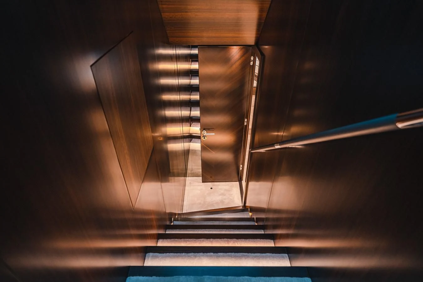 a dark staircase with light coming through aboard 90 OCEAN Yacht for Sale