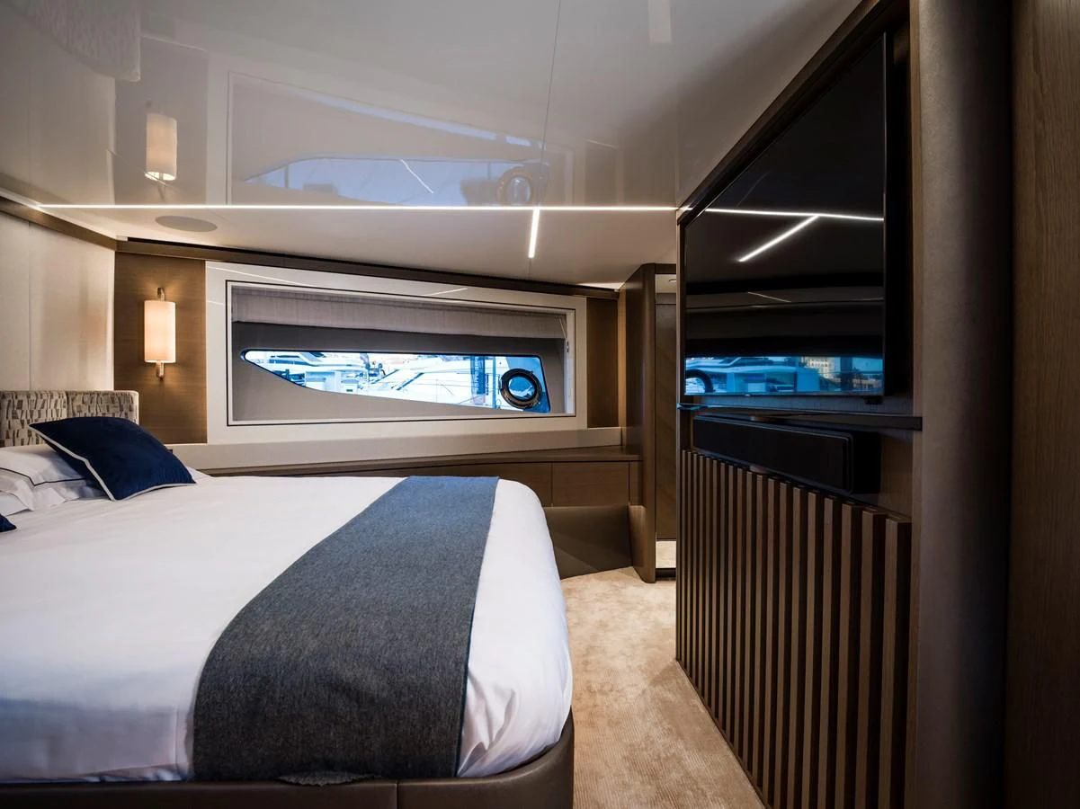 a bedroom with a bed and a window aboard 90 OCEAN Yacht for Sale