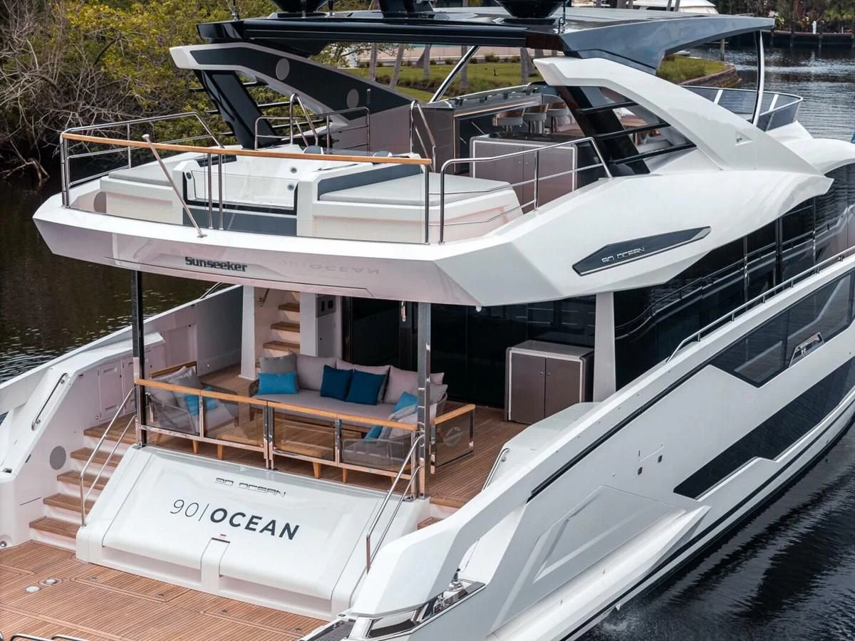 a white boat with a blue seat aboard 90 OCEAN Yacht for Sale