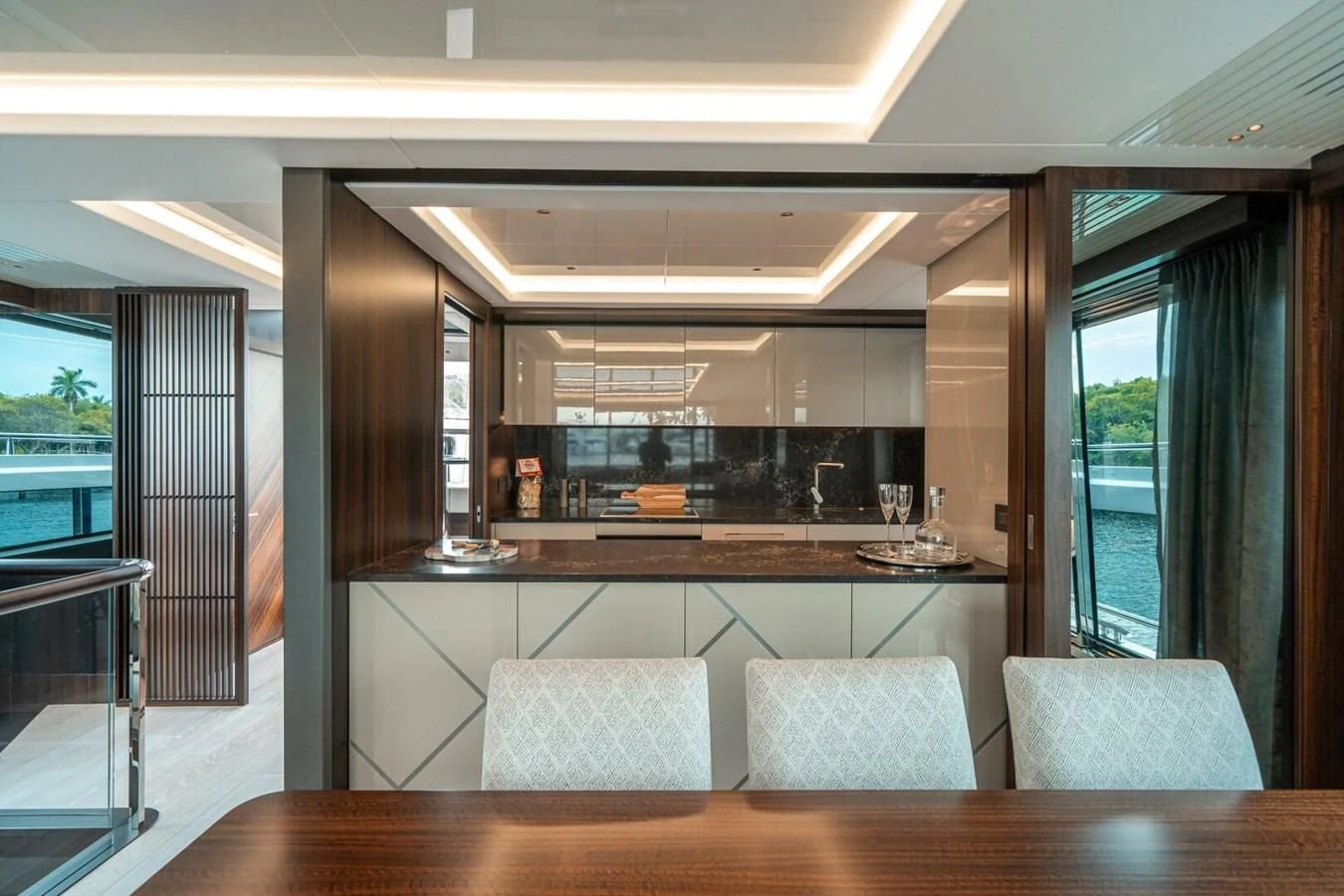 a room with a table chairs and a window aboard 90 OCEAN Yacht for Sale