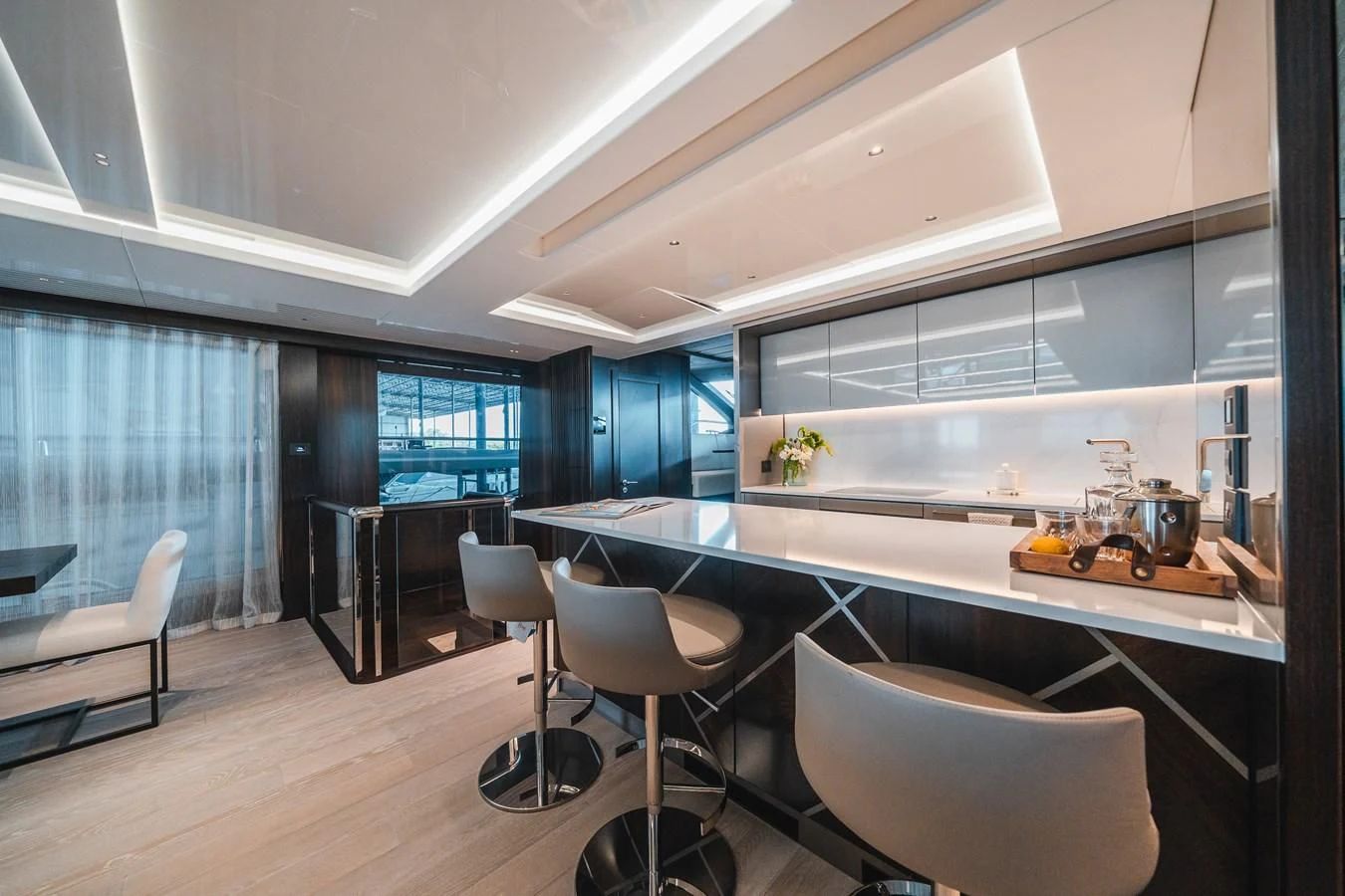 a large kitchen with white chairs aboard 90 OCEAN Yacht for Sale