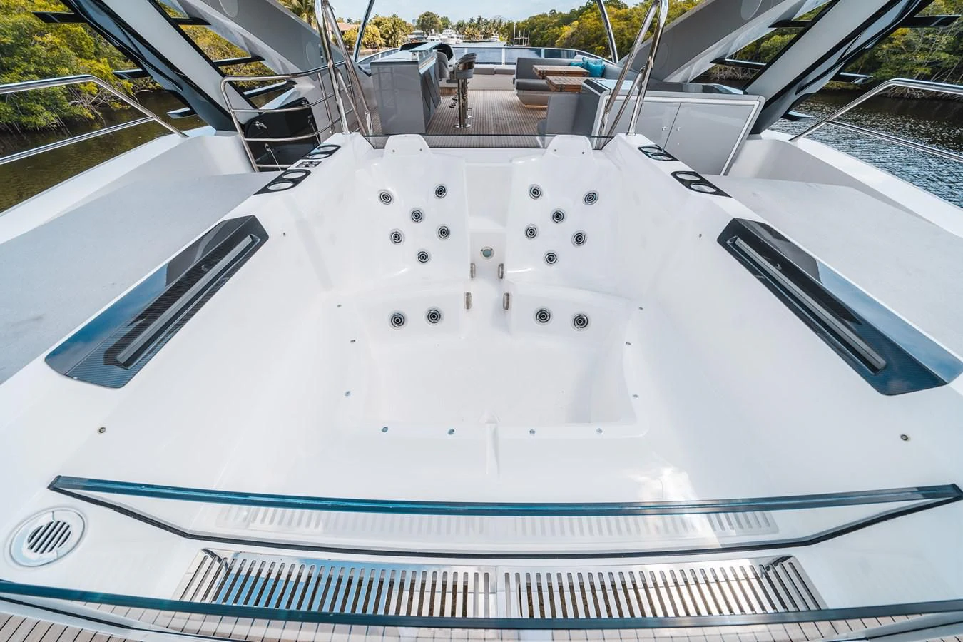 a white vehicle with black spots aboard 90 OCEAN Yacht for Sale