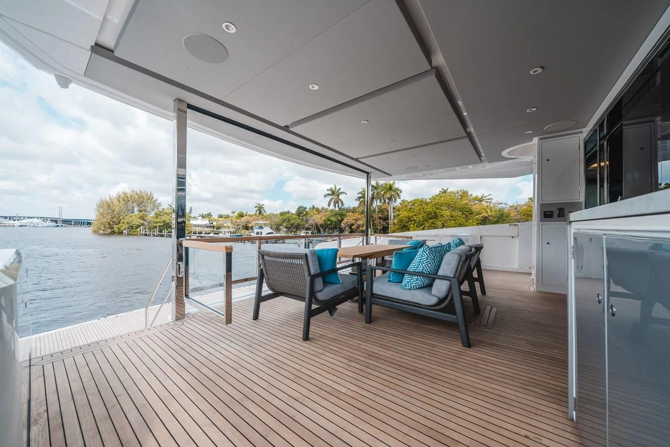 a deck with a table and chairs aboard 90 OCEAN Yacht for Sale