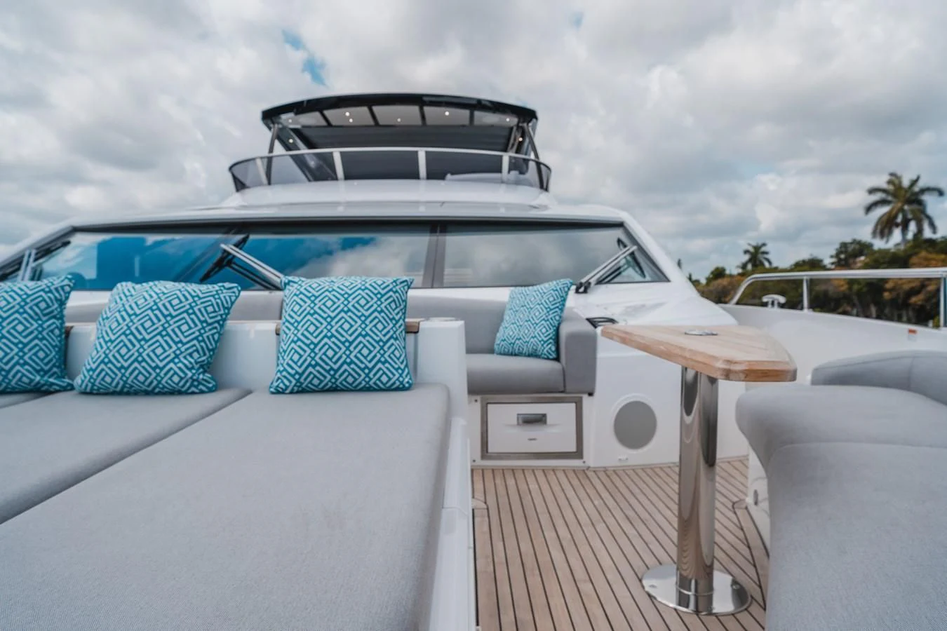 a white car with a table and chairs on a deck aboard 90 OCEAN Yacht for Sale