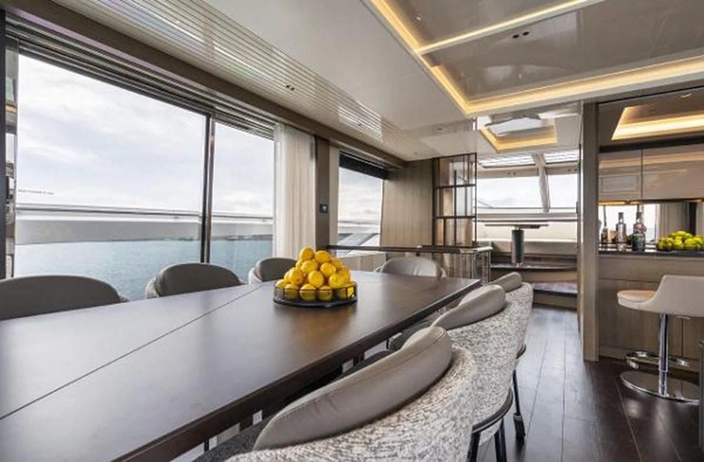 a large room with a table and chairs aboard 90 OCEAN Yacht for Sale