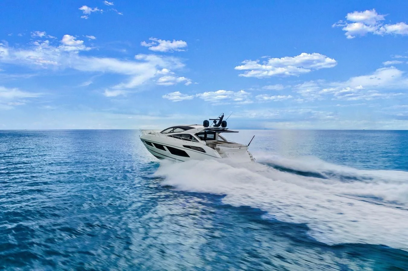 a helicopter flying over water aboard SUNSEEKER PREDATOR Yacht for Sale