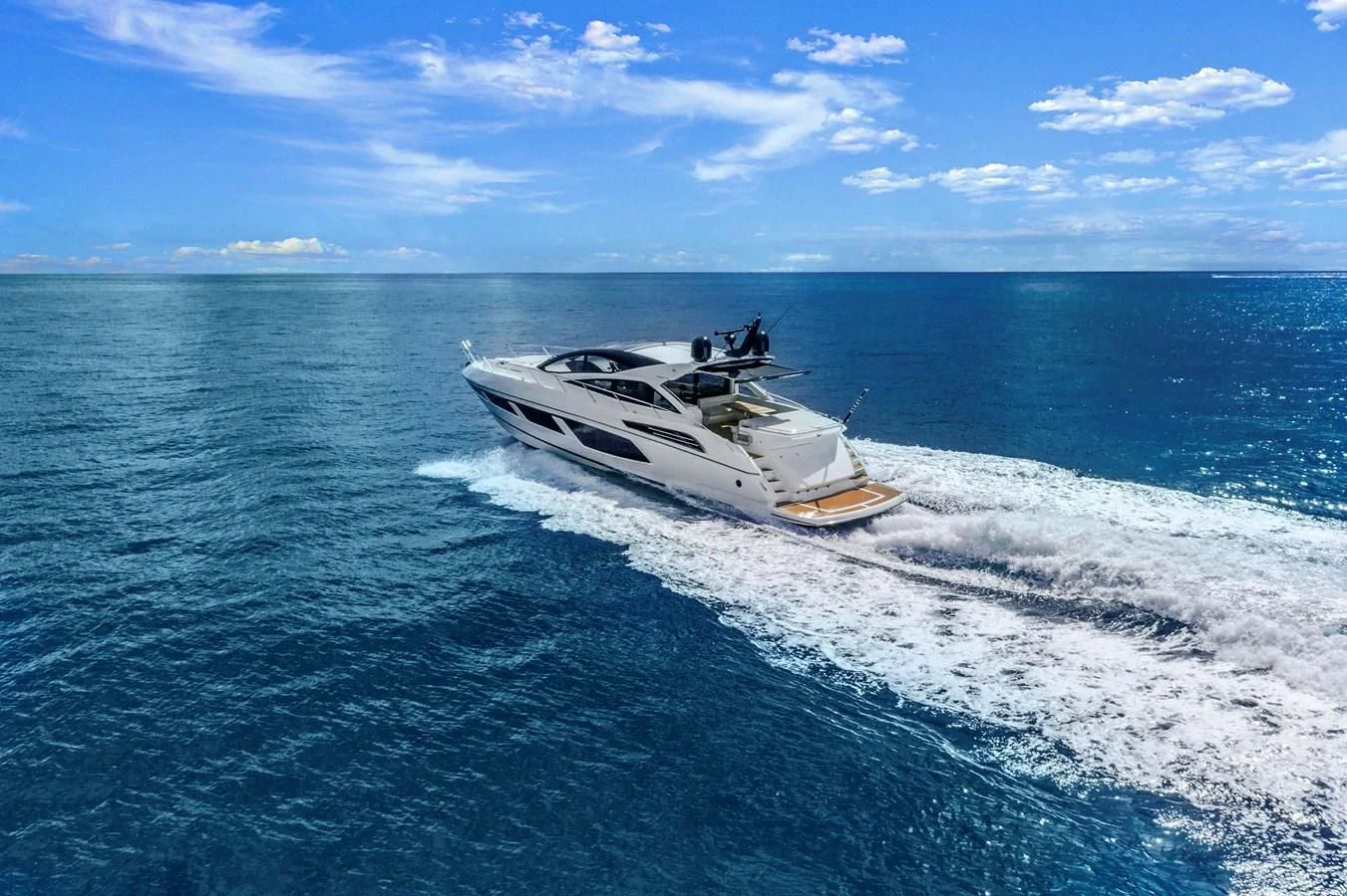 a helicopter flying over a boat in the water aboard SUNSEEKER PREDATOR Yacht for Sale