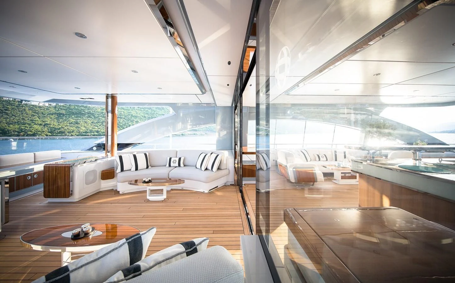 a room with a couch and a table and a view of the water aboard GAJA Yacht for Sale