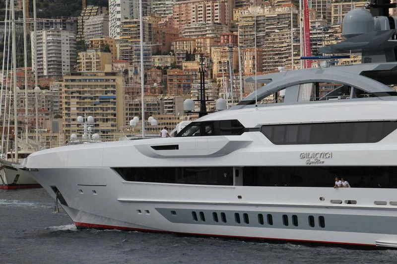 a white yacht in a harbor aboard GAJA Yacht for Sale