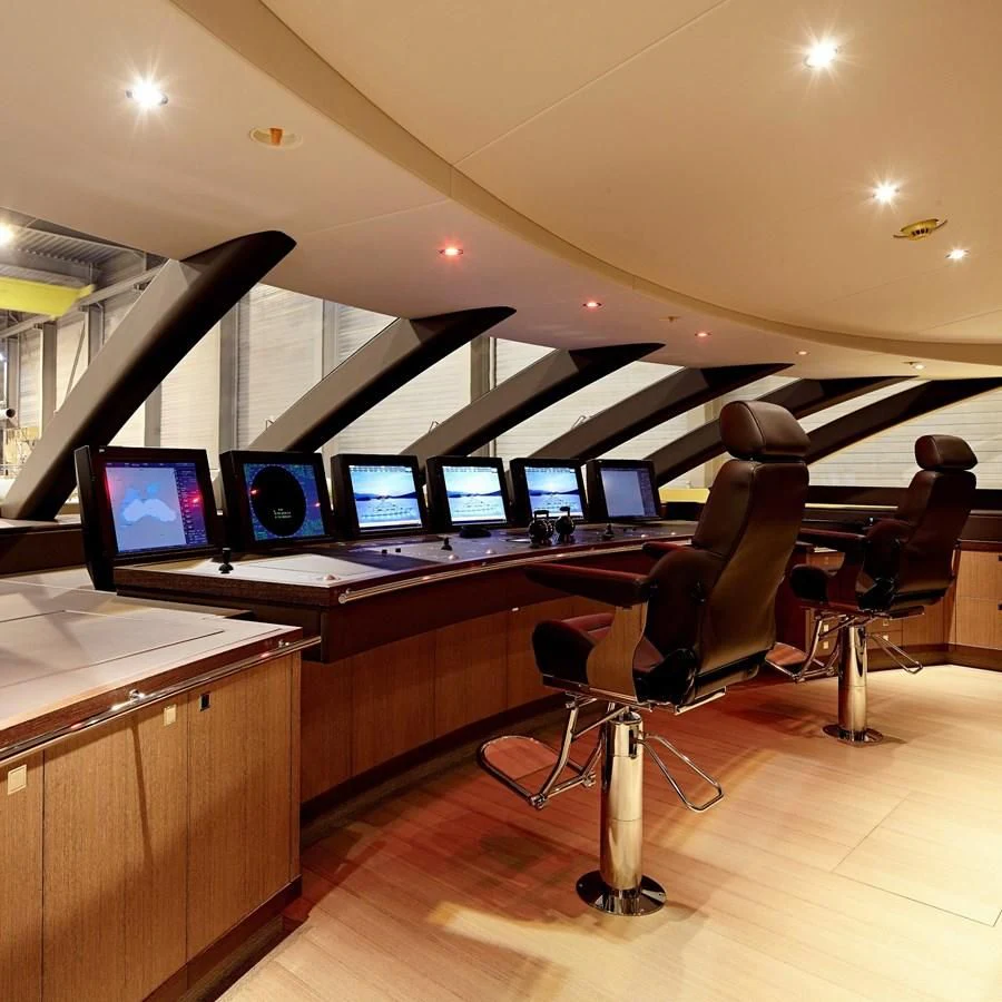 a room with computers and chairs aboard GAJA Yacht for Sale