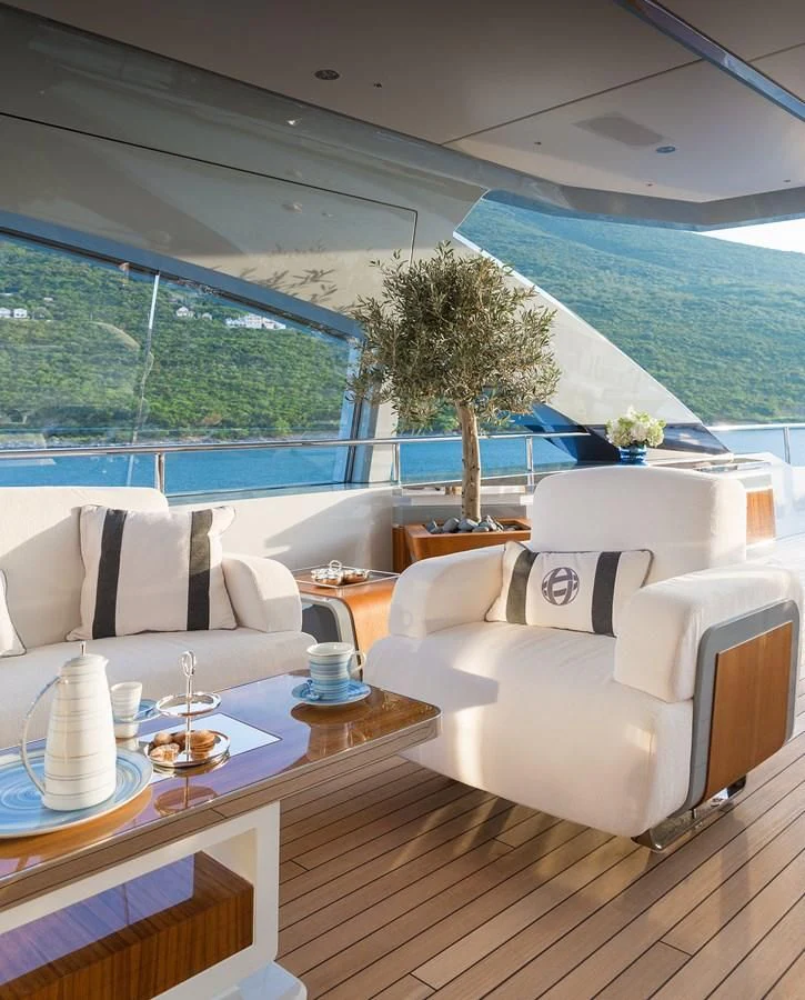a room with a table chairs and a view of the water aboard GAJA Yacht for Sale
