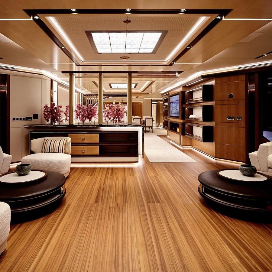 a room with a wood floor and a wood floor and white chairs aboard GAJA Yacht for Sale