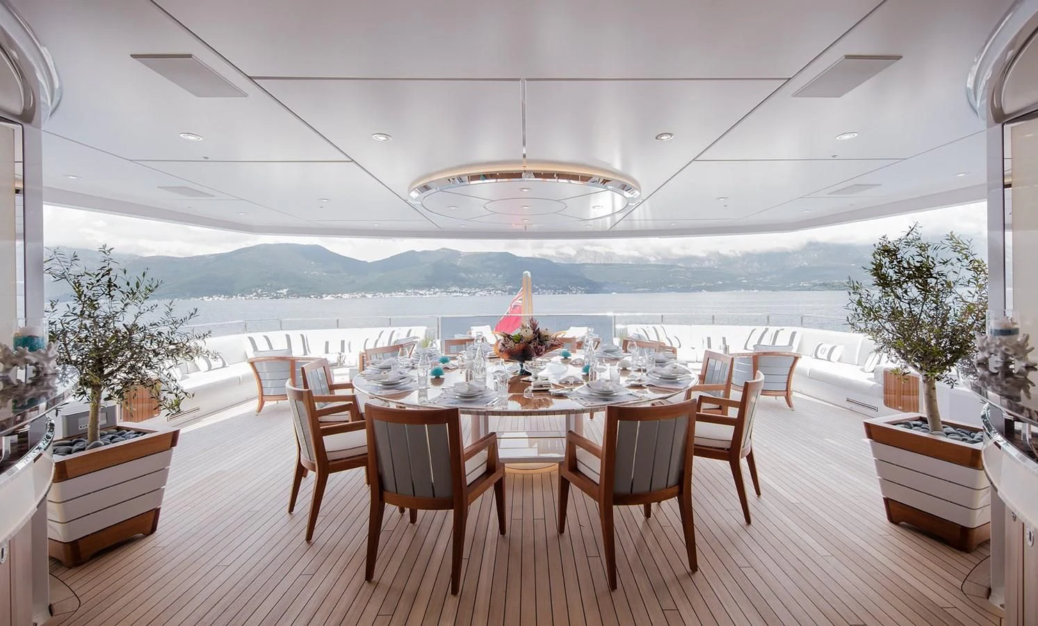 a room with tables and chairs aboard GAJA Yacht for Sale