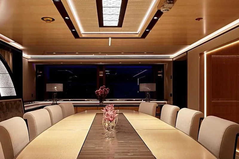 a room with a table chairs and a large window aboard GAJA Yacht for Sale