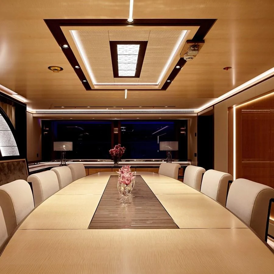 a room with a table and chairs aboard GAJA Yacht for Sale