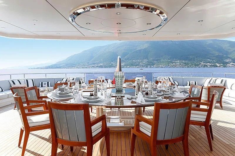 a restaurant with a view of the mountains in the background aboard GAJA Yacht for Sale