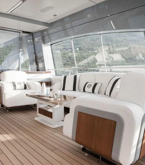 a room with a couch and a table and a window aboard GAJA Yacht for Sale