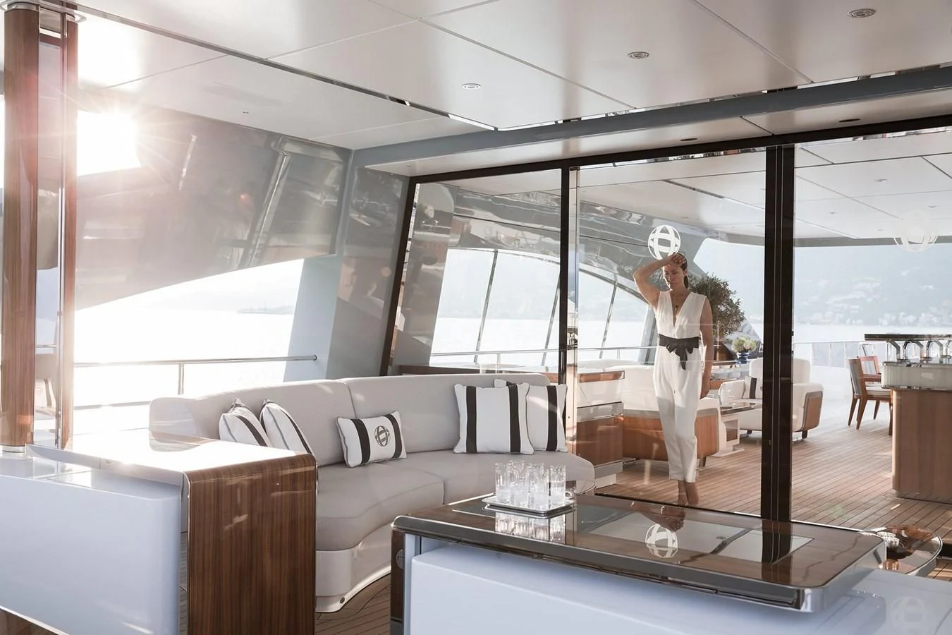 a person in a white dress in a room with a large window aboard GAJA Yacht for Sale