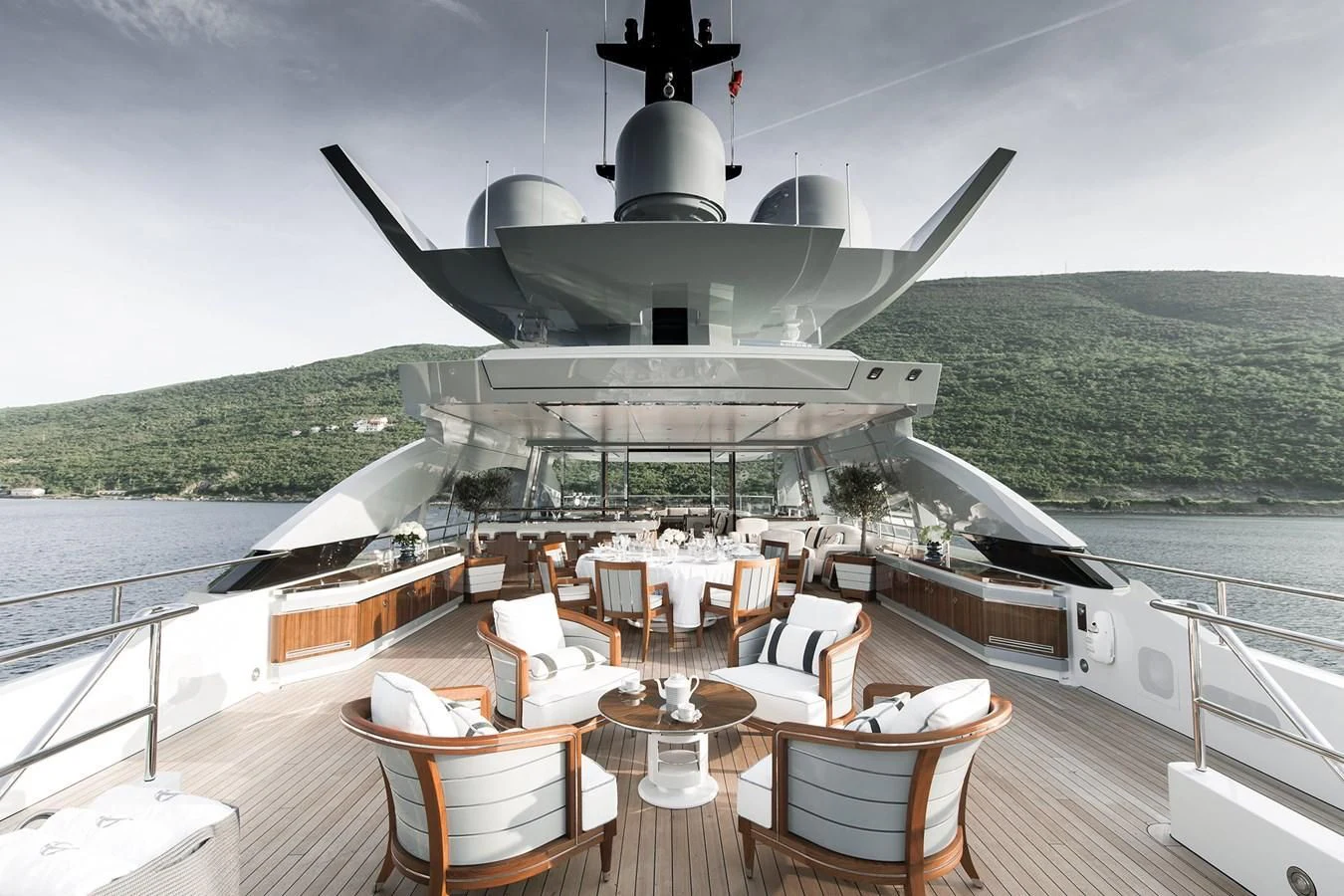a large white ship docked at a pier aboard GAJA Yacht for Sale