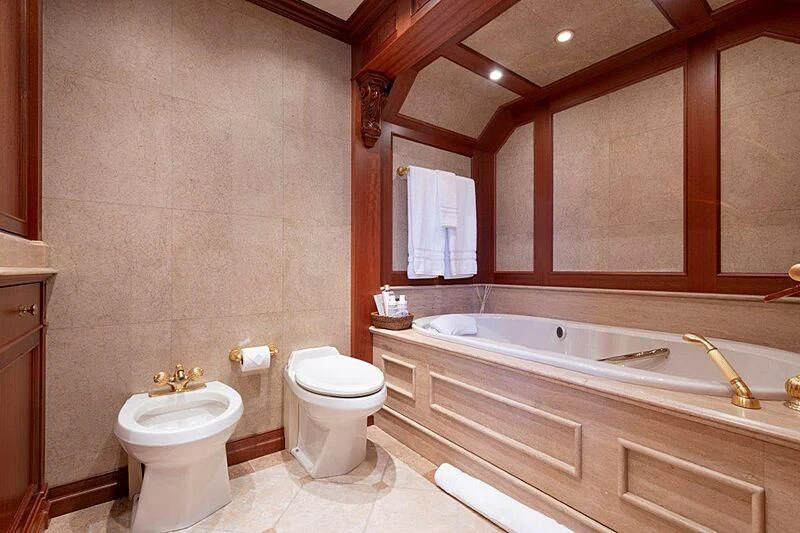 a bathroom with a tub toilet and sink aboard MAMAMIA Yacht for Sale