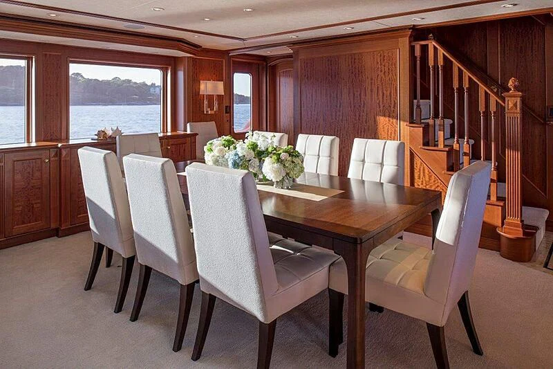 a table with chairs around it aboard MAMAMIA Yacht for Sale