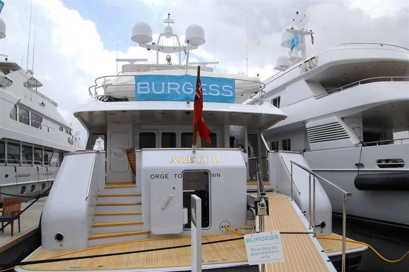 a large white ship with a flag on the deck aboard MAMAMIA Yacht for Sale