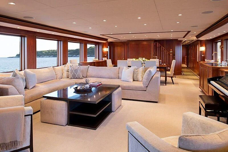 a living room with a couch and a piano aboard MAMAMIA Yacht for Sale