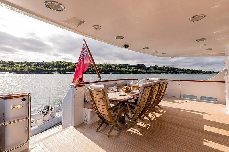 a table and chairs on a deck aboard MAMAMIA Yacht for Sale