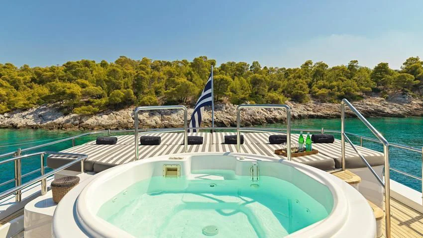 a swimming pool with a flag on it aboard ALMA Yacht for Sale