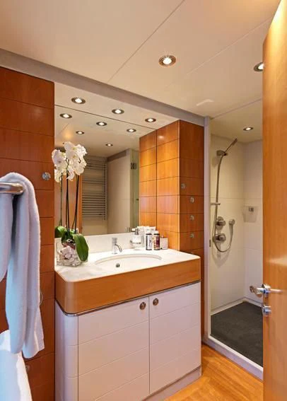 a bathroom with a large mirror aboard ALMA Yacht for Sale