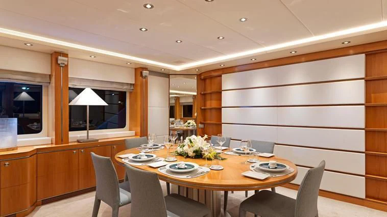 a dining room with a table and chairs aboard ALMA Yacht for Sale