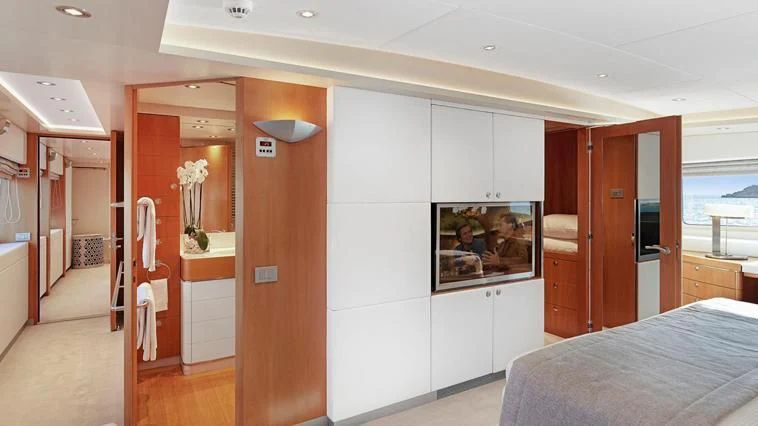 a bedroom with a bed and a closet aboard ALMA Yacht for Sale