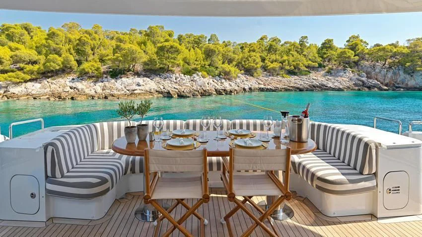 a table set for a meal on a boat aboard ALMA Yacht for Sale