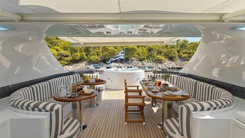 a room with a table and chairs aboard ALMA Yacht for Sale