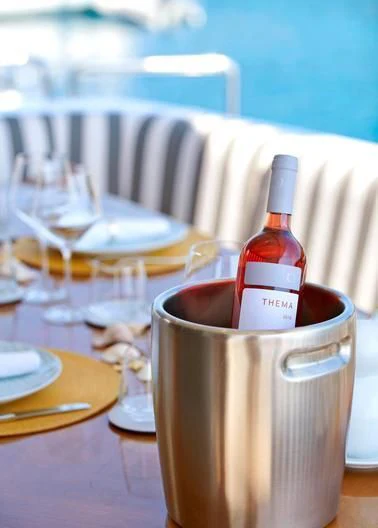 a bottle of liquor on a table aboard ALMA Yacht for Sale