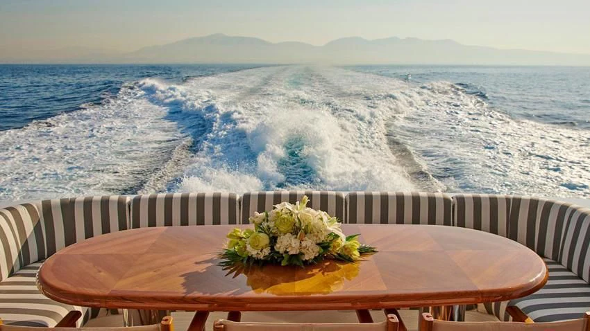 a table with flowers on it aboard ALMA Yacht for Sale