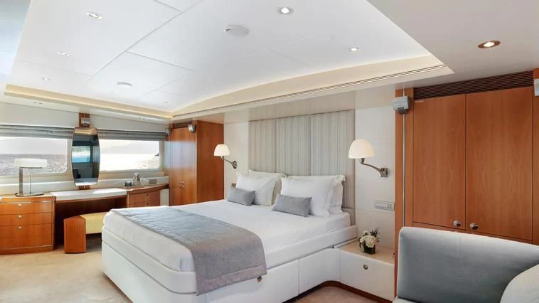 a bedroom with a bed and a desk aboard ALMA Yacht for Sale