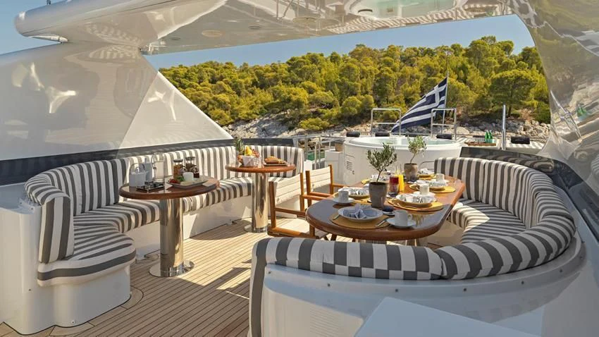 a room with a table and chairs aboard ALMA Yacht for Sale