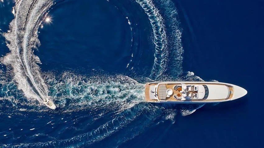 a bottle of alcohol on a blue surface aboard ALMA Yacht for Sale