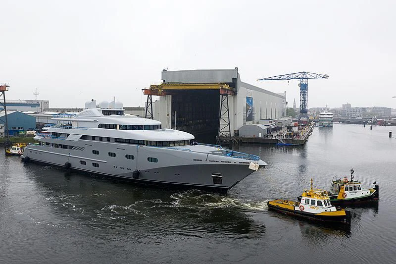 a large white boat sits next to a smaller boat aboard PEGASUS VIII Yacht for Sale