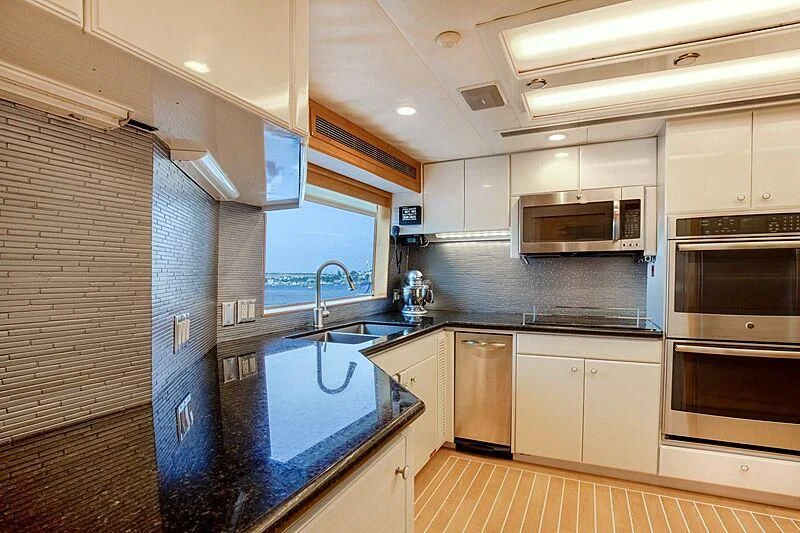 a kitchen with white cabinets aboard LONE STAR Yacht for Sale